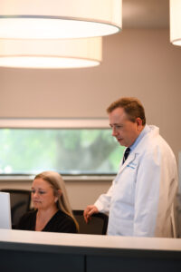 Dr. Zeni and Amy Statler at the office desk